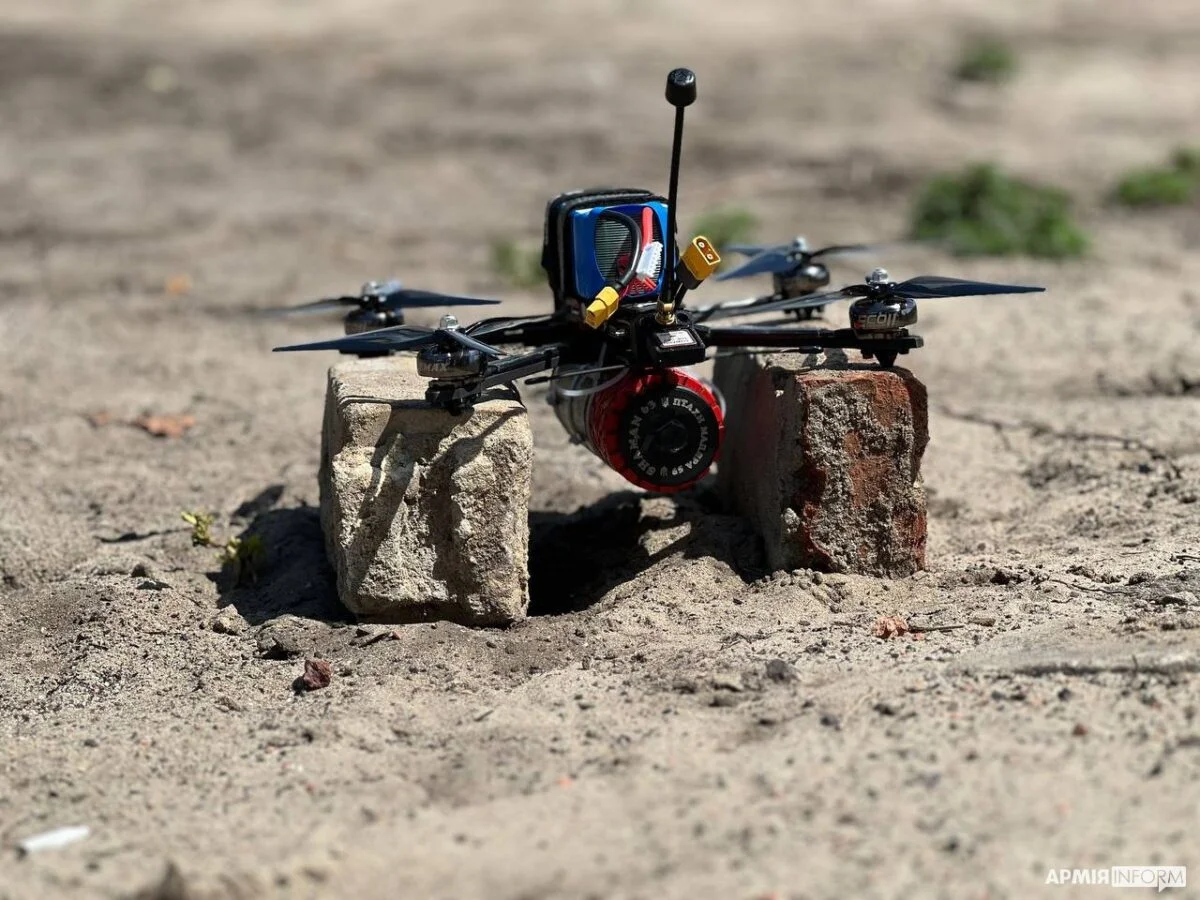 A small Ukrainian military FPV quadcopter resting on supports