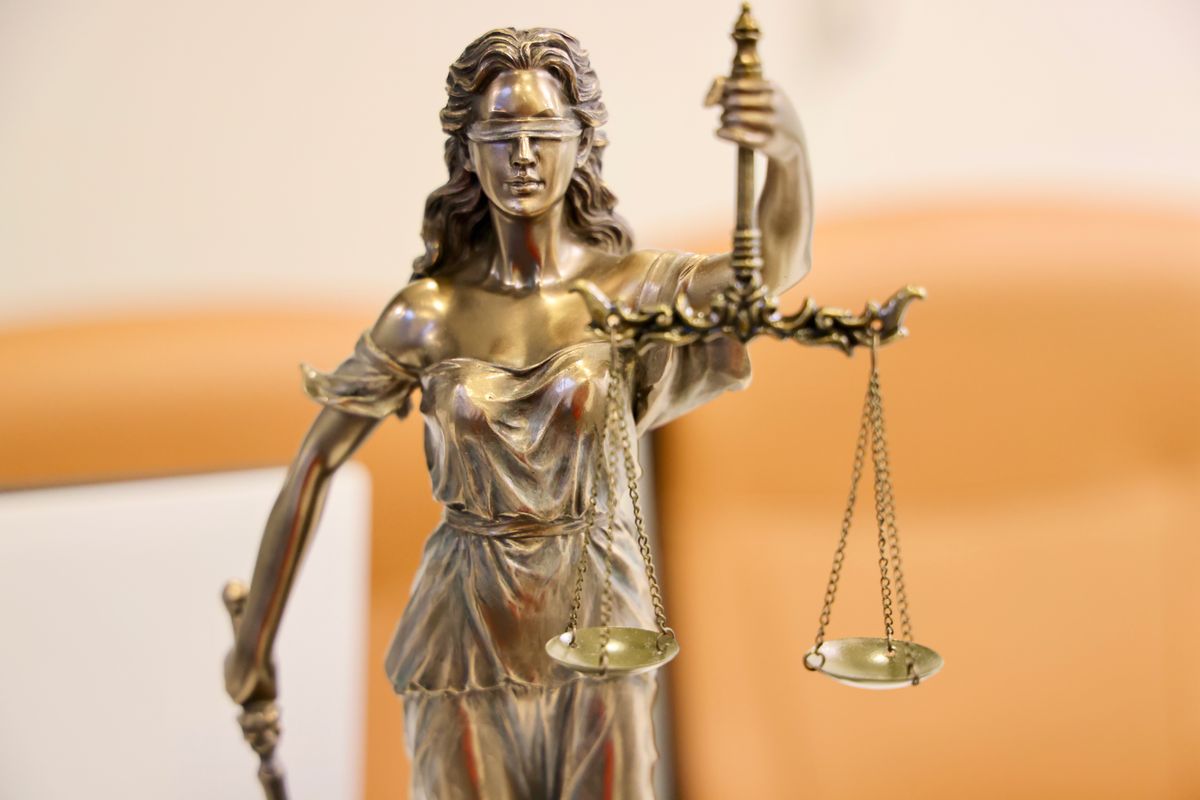A statue of Lady Justice holding the scales, symbolising fairness and accountability.