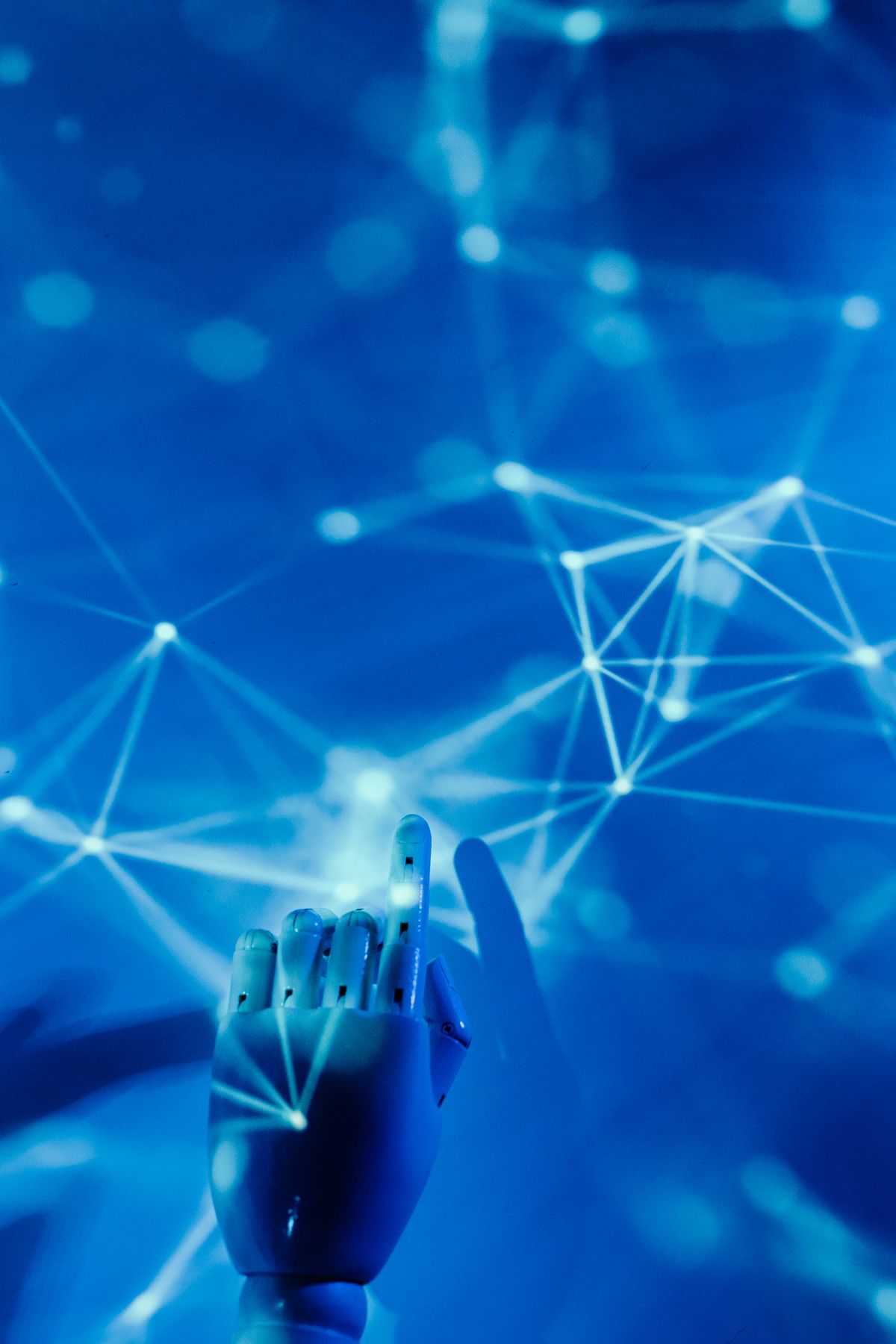 A robotic hand reaching towards a glowing network of connected data points, representing AI linking fragmented information.