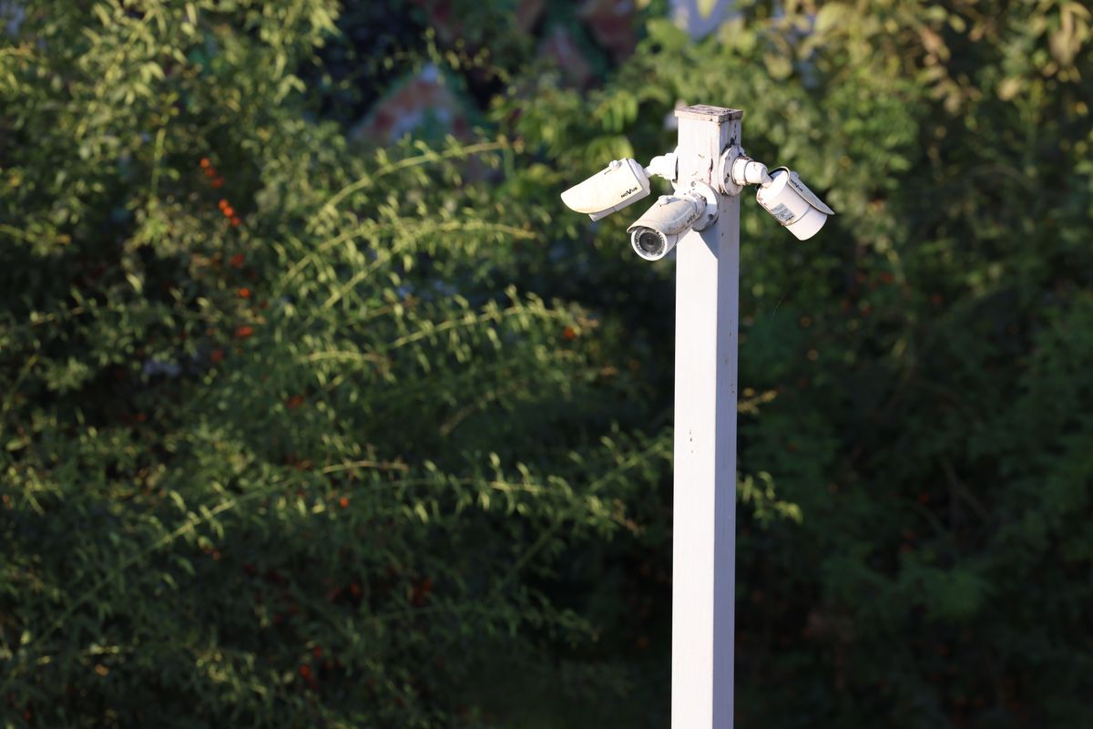 A cluster of CCTV cameras mounted together outdoors.