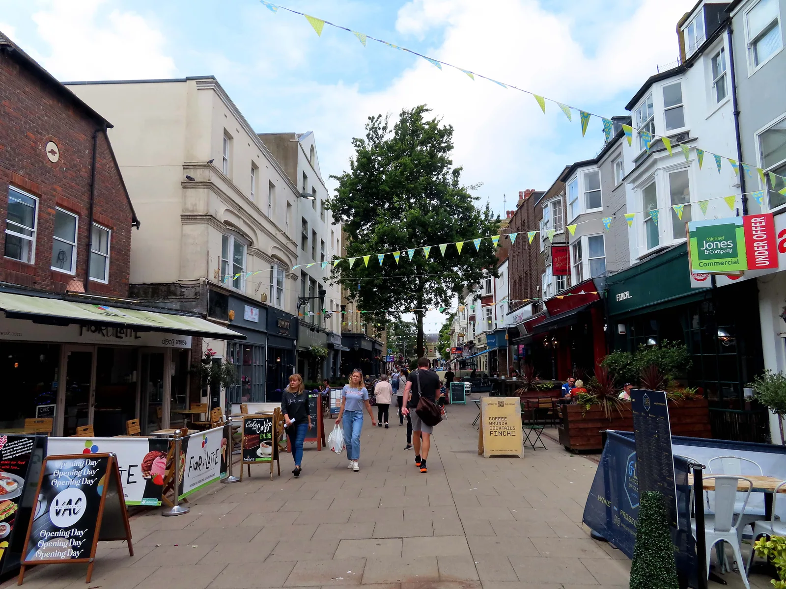 Shoppers and cafés on pedestrianised Warwick Street in Worthing.